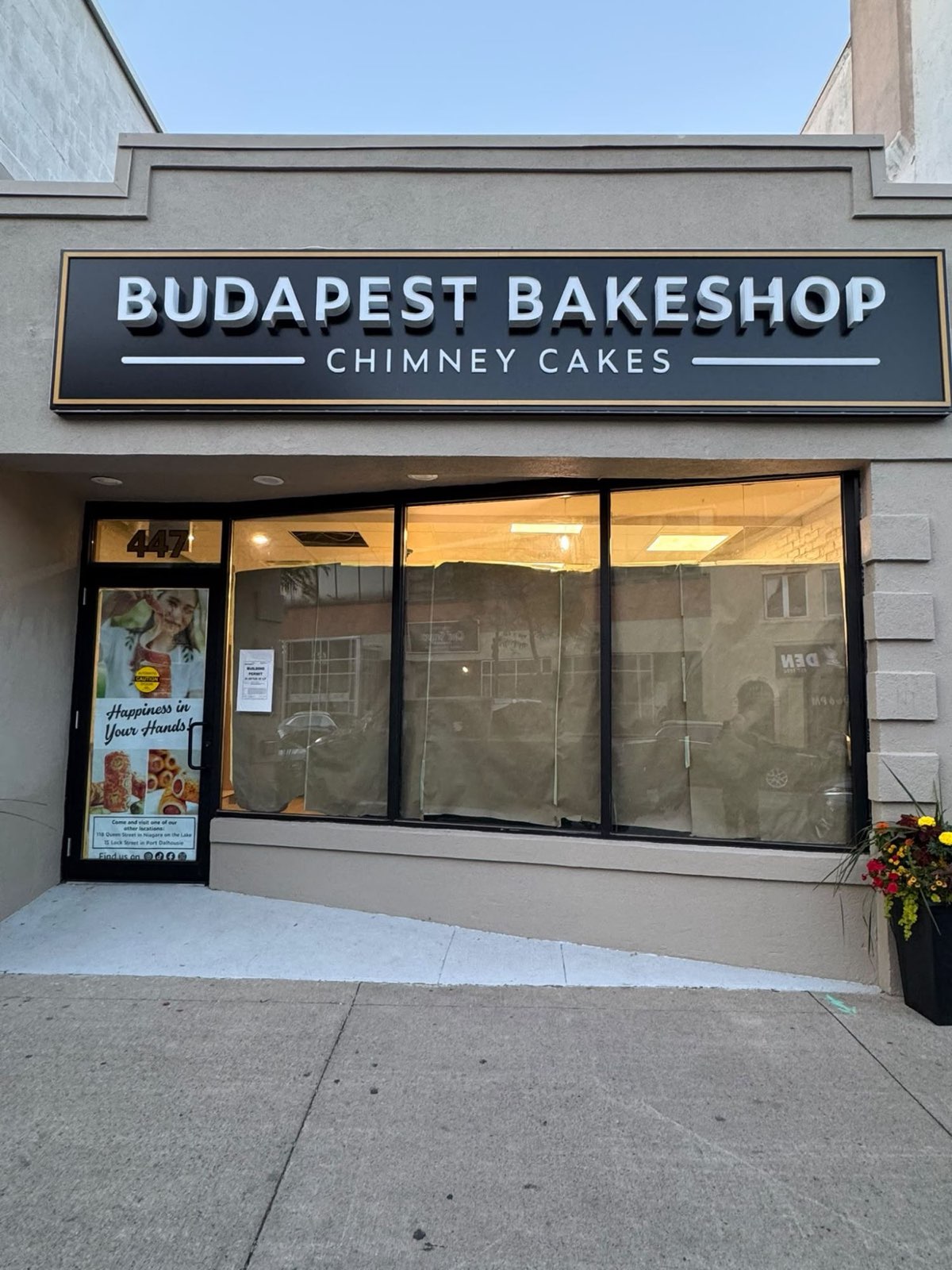 Bakeshop storefront with black-framed display windows and entry door