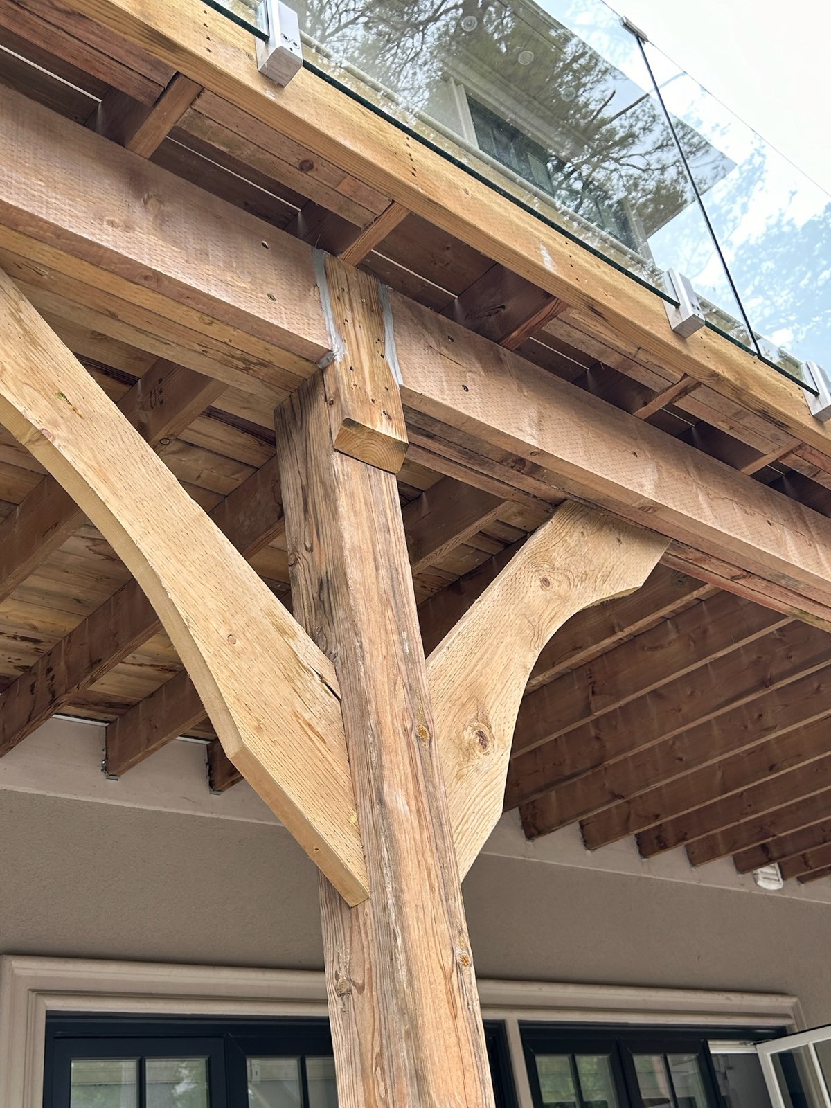 Wood framing of a patio cover during construction, before the ceiling and trim were finished