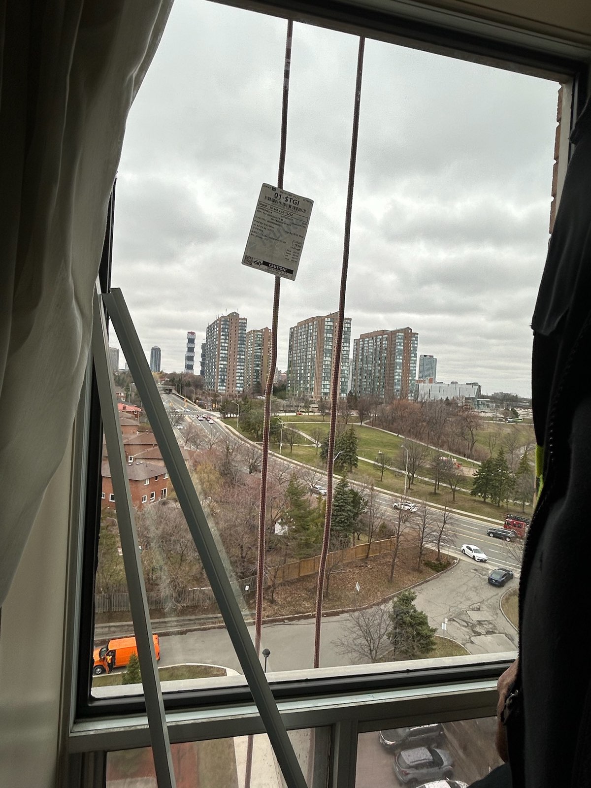 High-rise window opening during glass replacement, with the city below